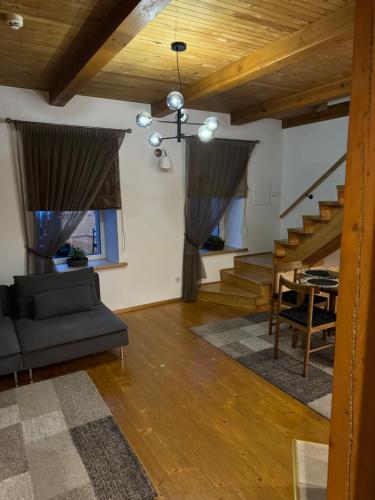 a living room with a couch and a table at Laurentroom Townhouse in Ukmergė