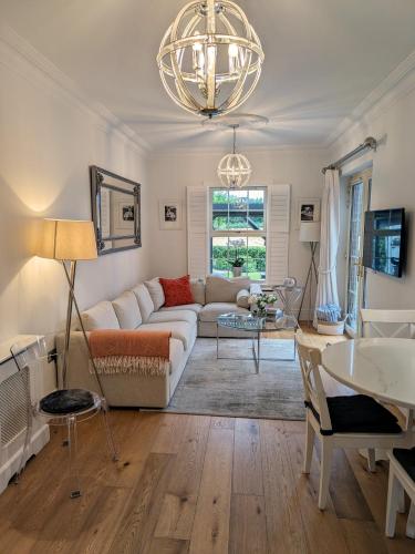 a living room with a couch and a table at Lady Hill, Royal Hillsborough in Hillsborough