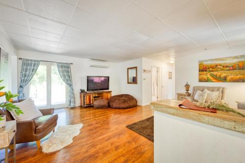 a living room with a couch and a tv at Charming Milk Barn Home on Vineyard Estate in Forestville
