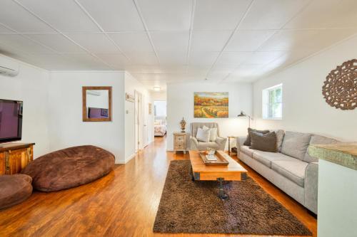 a living room with a couch and a table at Charming Milk Barn Home on Vineyard Estate in Forestville