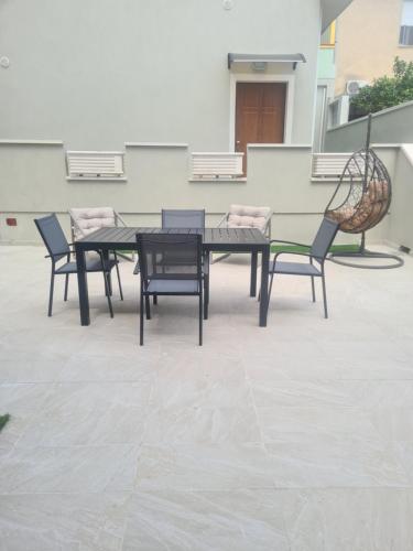 a table and chairs sitting on a patio at Casa Antonella in Sìnnai