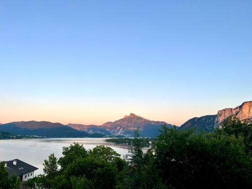 a view of the water with mountains in the background at Ferienhof Mitterbauer in Mondsee
