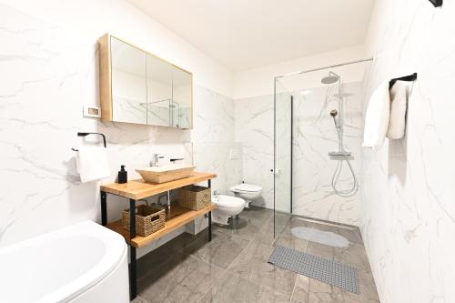 a white bathroom with a toilet and a shower at Villa Katarina in Vilanija