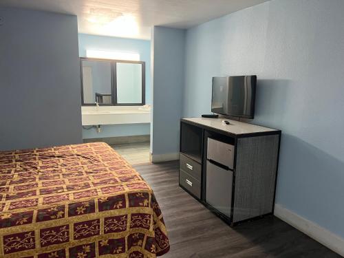 a bedroom with a bed and a tv on a dresser at crown inn in Memphis