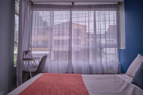 Ένα ή περισσότερα κρεβάτια σε δωμάτιο στο Apartamentos y Loft Laureles