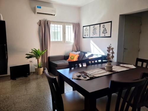 a living room with a table and a couch at Casa Oliva in Tinogasta