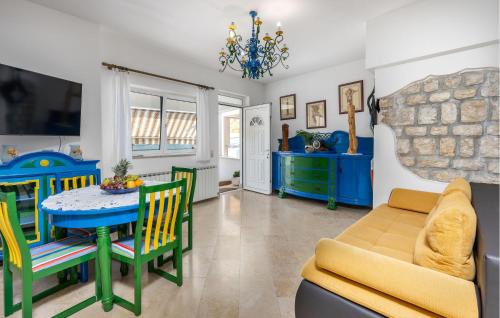 a living room with a table and chairs and a couch at 1 Bedroom Awesome Apartment In Kampor in Kampor