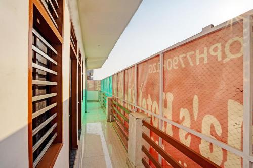 a corridor of a building with a brick wall at Hotel O Chawla's Hotel & Restaurant in Gurgaon