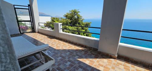 a balcony with a view of the ocean at Blue View in Qeparo