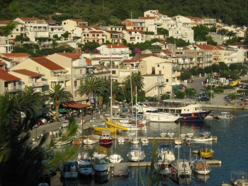 a group of boats docked in a marina with buildings at Adria Apartments in Podgora