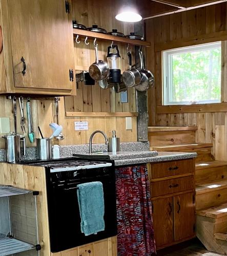 a kitchen with a stove and a sink at Escape to Tree House Island Life in Monmouth