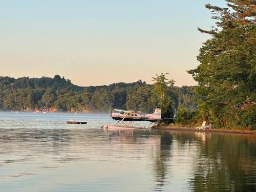 a boat is docked on the shore of a lake at Island Aframe Adventure in Monmouth
