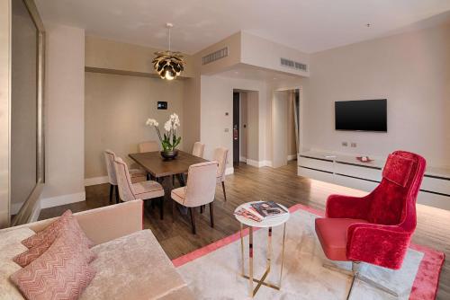 a living room with a couch and a table at NH Collection Palazzo Cinquecento in Rome