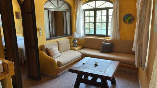 a living room with a couch and a table at Botanical Studios Sayulita in Sayulita