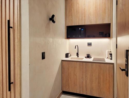 a small kitchen with a sink and a cabinet at Kuuna Luxury Stays by Wynwood House in Medellín
