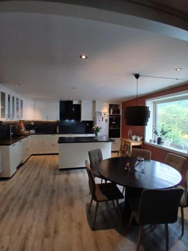 a kitchen and dining room with a table and chairs at Apartment in Stryn in Stryn