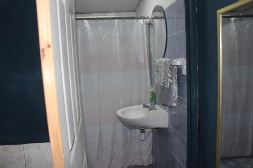 a bathroom with a sink and a shower with a mirror at Suite 608 Ciudad Jardín San Miguel in San Miguel