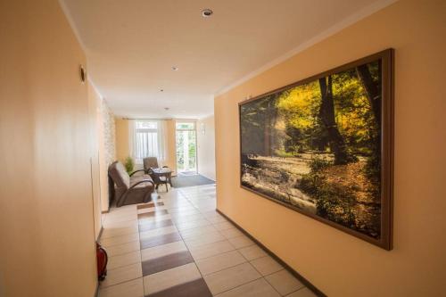 a living room with a large painting on the wall at Dom Wczasowy Lech in Susiec
