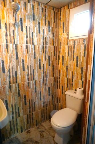 a bathroom with a toilet and a sink at Pospolita Guest House in Kutaisi