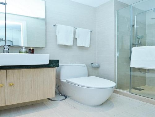 a bathroom with a toilet and a sink and a shower at Hotel Noble Haven Unit OF Lacasa Near Airport in New Delhi