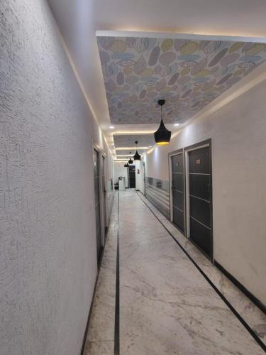 a hallway with a ceiling with a painting on it at hotel delight town by 03 in Agra