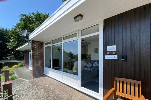 a sliding glass door on the side of a house at Chalet 8 The Woodlands in Tywyn
