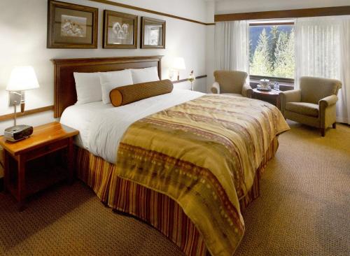 a hotel room with a large bed and a window at Alyeska Resort in Girdwood
