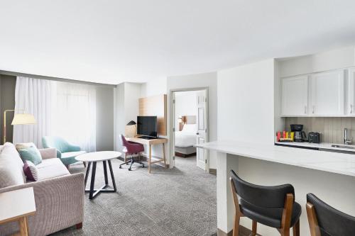 a living room with a kitchen and a living room at Staybridge Suites Peoria Downtown by IHG in Peoria