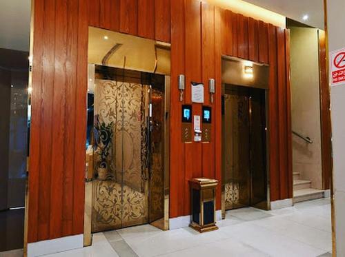 a lobby with three elevators in a building at Kayan Al Taif Hotel in Taif