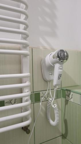 a blow dryer in a bathroom with a window at Pokoje u Piotra in Tczew