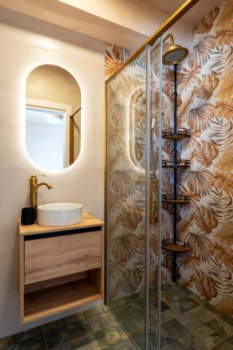 a bathroom with a shower with a sink and a mirror at Villa Mar Rompido in El Rompido