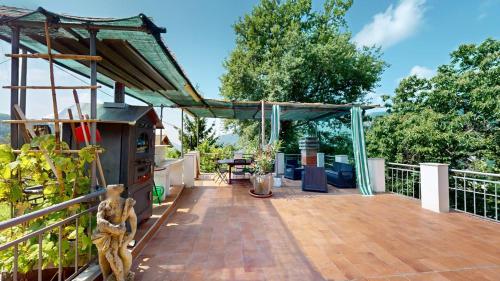a deck with a grill on top of a house at La Ciliegia in Uscio