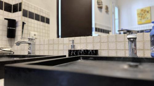a bathroom with two sinks and a mirror at La Ciliegia in Uscio