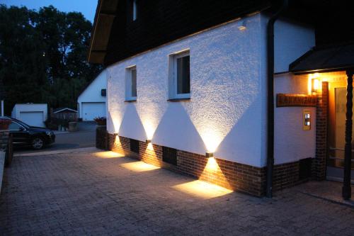 a building with lights on the side of it at Laxmi-Haus Ferienwohnung Bayreuth in Bayreuth