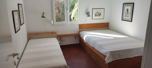 a small bedroom with two beds and a window at Horizon - Sunset & Seaview Villa in Potos