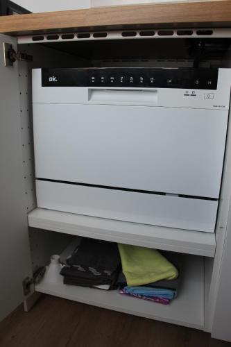 a white stove top oven sitting in a kitchen at Laxmi-Haus Ferienwohnung Bayreuth in Bayreuth