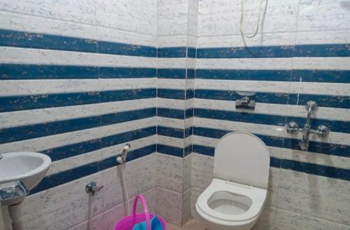a bathroom with a toilet and a sink at Hotel Sana a family-friendly guest house in Kolkata