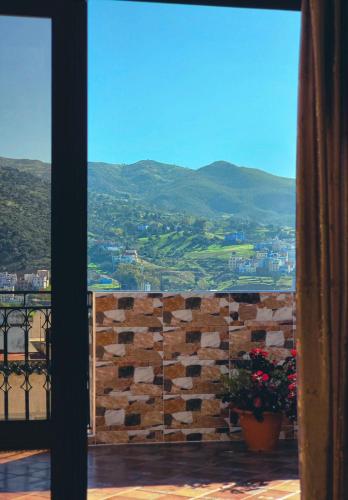 a window with a view of a mountain view at Chefchaouen Amjad in Chefchaouene