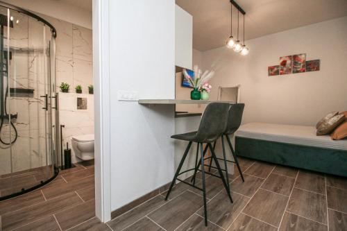 a small room with a bed and a desk and a chair at Apartman Lamanova in Rovinj