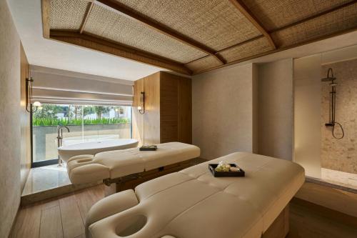 a bathroom with a tub and a sink and a bath tub at The Millen Penang, Autograph Collection in George Town