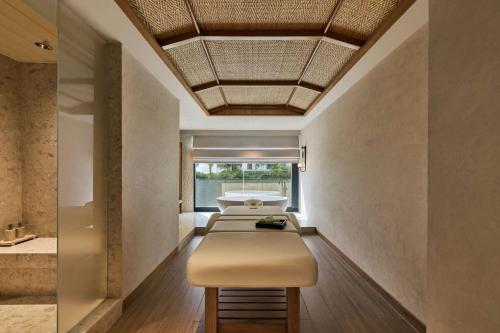 a row of beds in a room with a ceiling at The Millen Penang, Autograph Collection in George Town