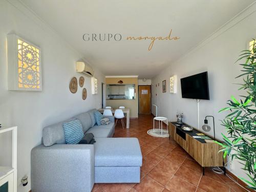 a living room with a couch and a tv at Grupo Morgado - Quinta do Morgado - Morgado Privilege in Tavira