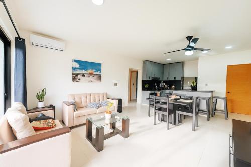 a living room with a couch and a table at Modern 3 Bedroom Penthouse Apartment with Free Parking in San Felipe de Puerto Plata
