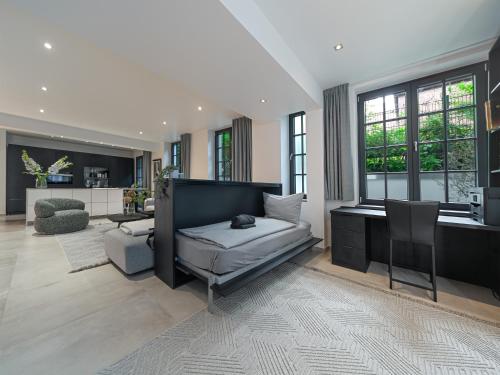 a large living room with a bed and a desk at Luxury Design Loft in Hamburg