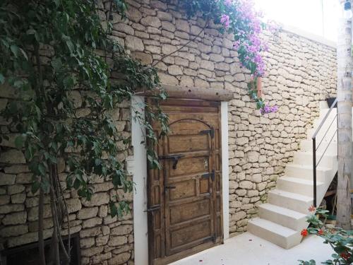 an entrance to a stone building with a wooden door at Tigmi Anis Essaouira Diabat in Essaouira