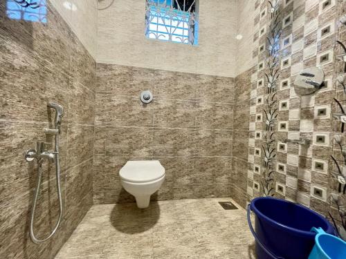 a bathroom with a shower and a toilet and a tub at Coastal Hideout 1bhk Colva anirah Homes in Colva
