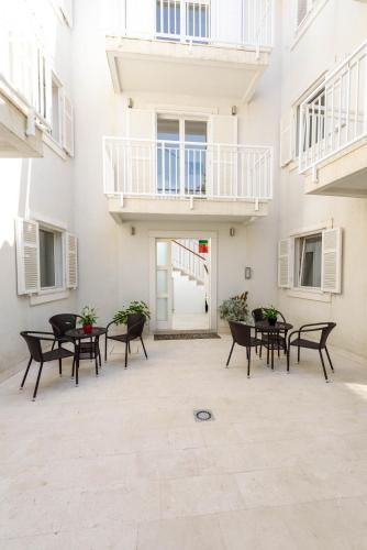 a courtyard with tables and chairs in a building at Apartments Gea Trogir in Trogir