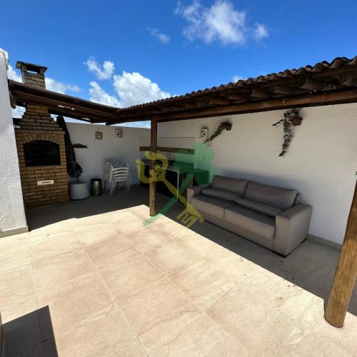 a patio with a couch and a table on a patio at Duplex com Jacuzzi apt 315 Muriu Beach Village in Ceará-Mirim