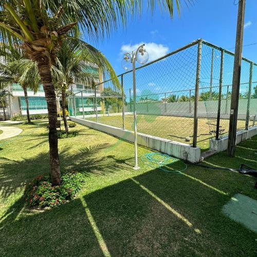a volley ball court with a palm tree in a park at Duplex com Jacuzzi apt 315 Muriu Beach Village in Ceará-Mirim