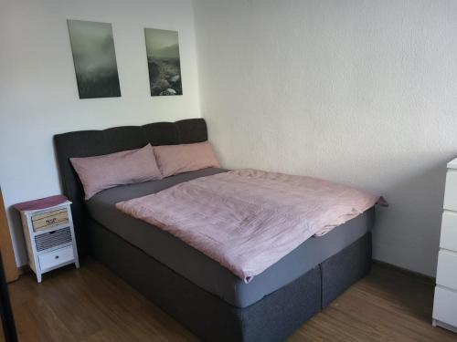 a small bed in a room with at C&V 4 Personen 3 Zimmer Central Smart TV Boxspringbett in Kaiserslautern